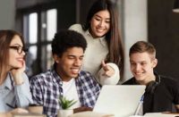 Group of students around a computer
